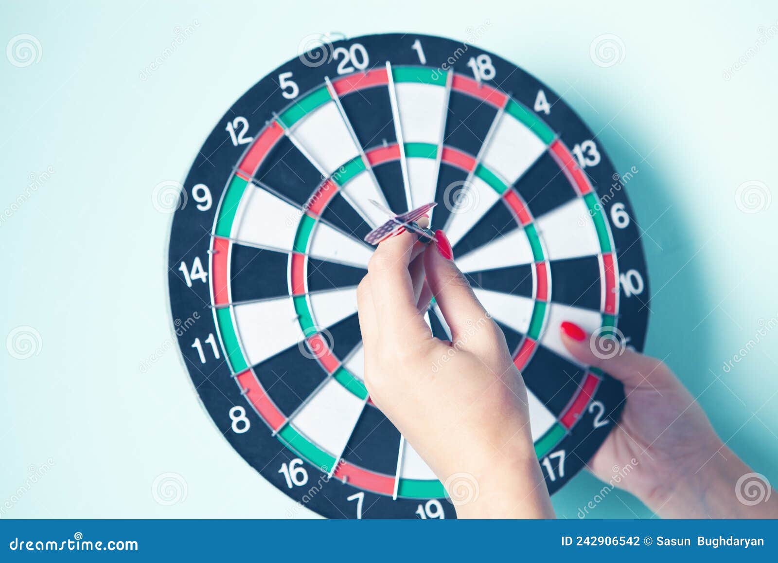 Woman Puts a Dart in the Center Stock Photo Image of competition