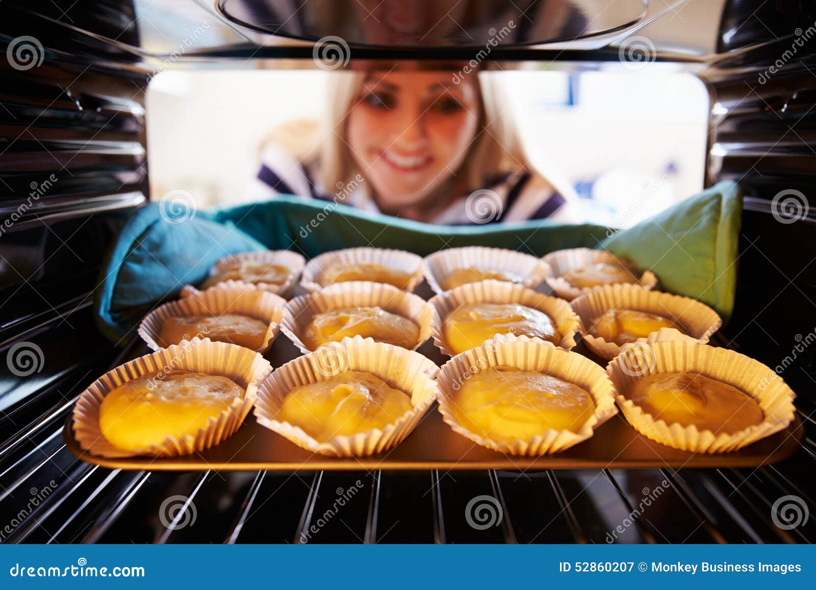 Woman Putting Cupcakes into Oven To Bake Stock Image Image of person