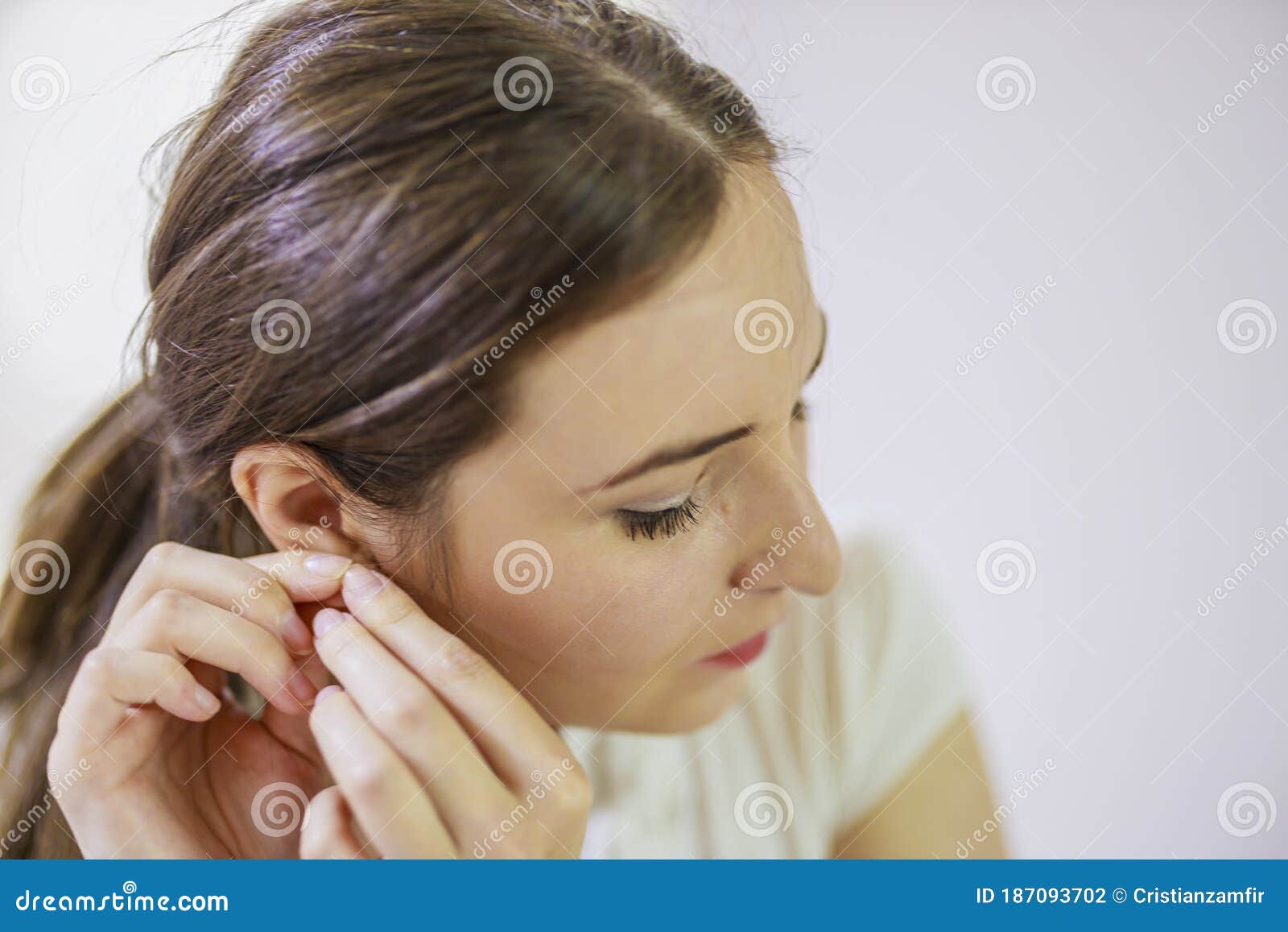 Woman Putting in Earrings on Her Ears Stock Photo Image of earrings