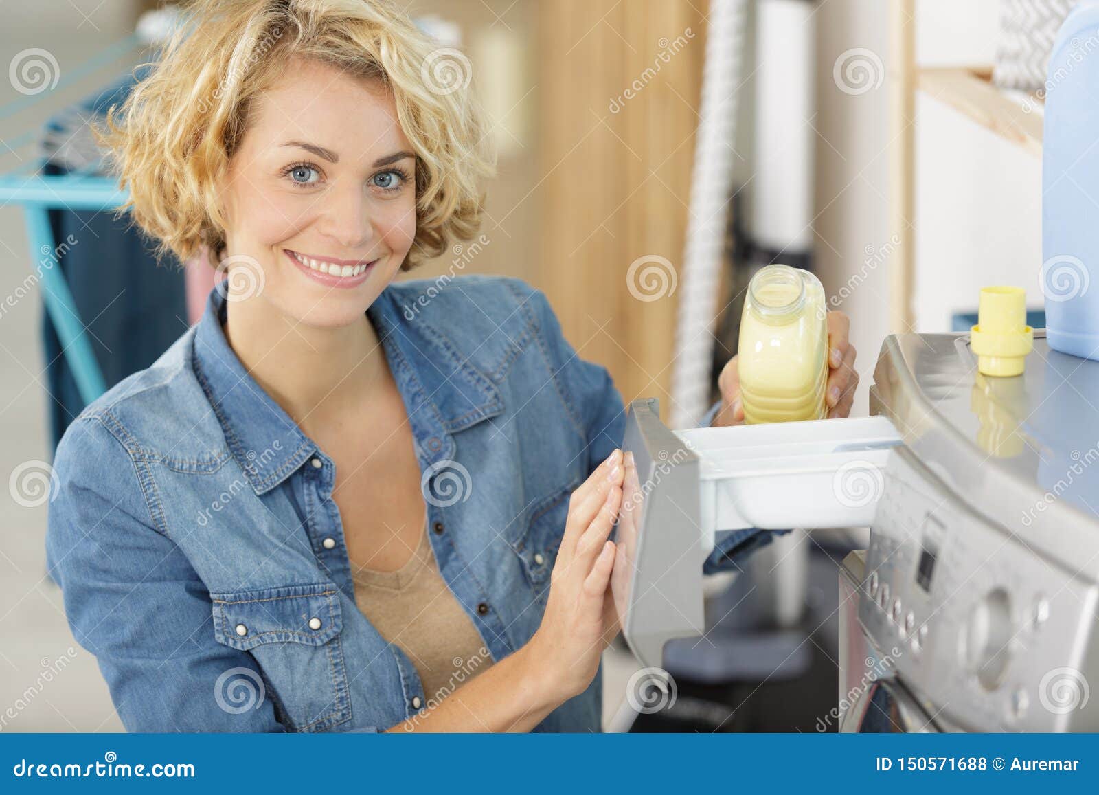 Woman Putting Liquid Detergent in Washing Machine Stock Photo Image