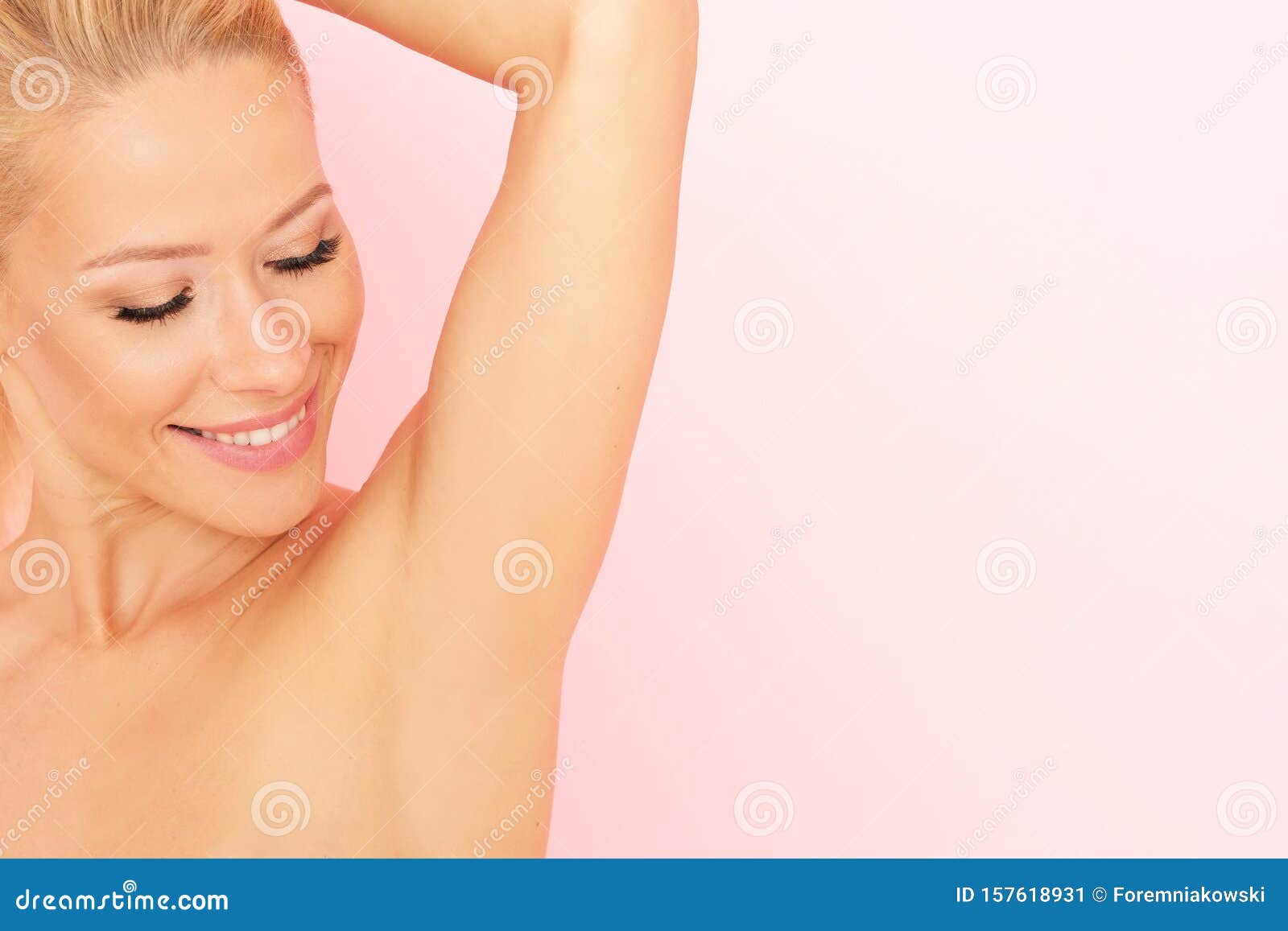 close up of smooth armpit. smiling woman touching her axilla.