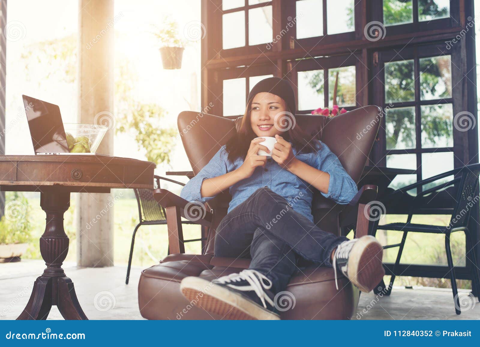 Woman Raising with a Coffee Cup,smiles Lying on the Couch, Sofa. Stock ...
