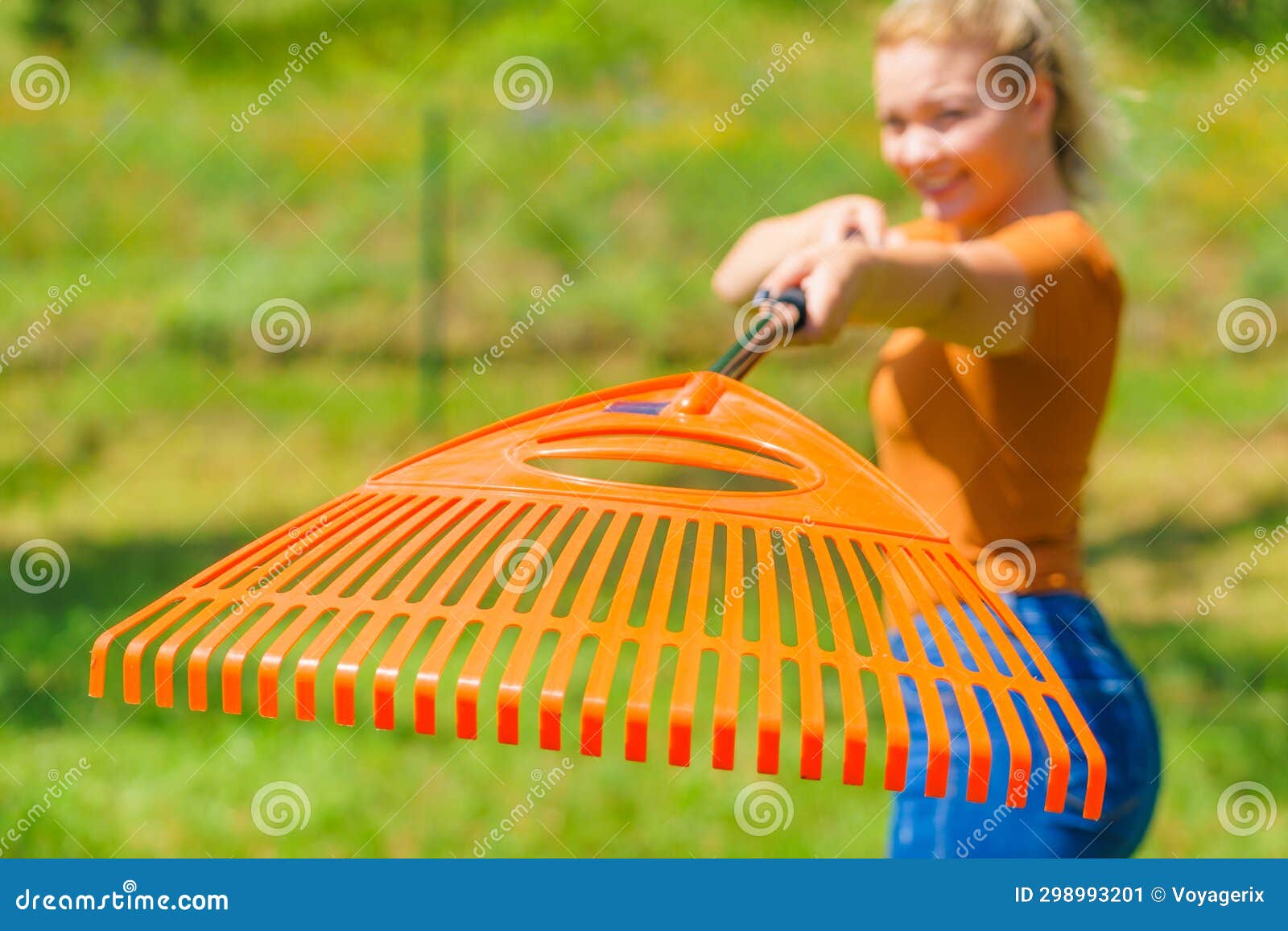 Woman with rake in garden stock image. Image of woman 298993201