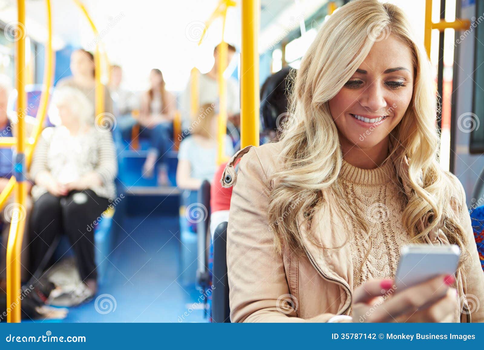 woman reading text message on bus
