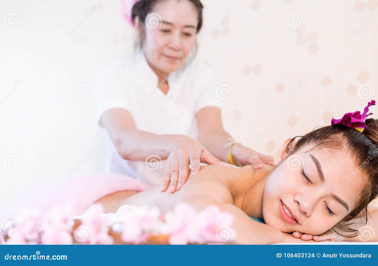 Woman Receiving Oil Massage On The Back In Thai Massage