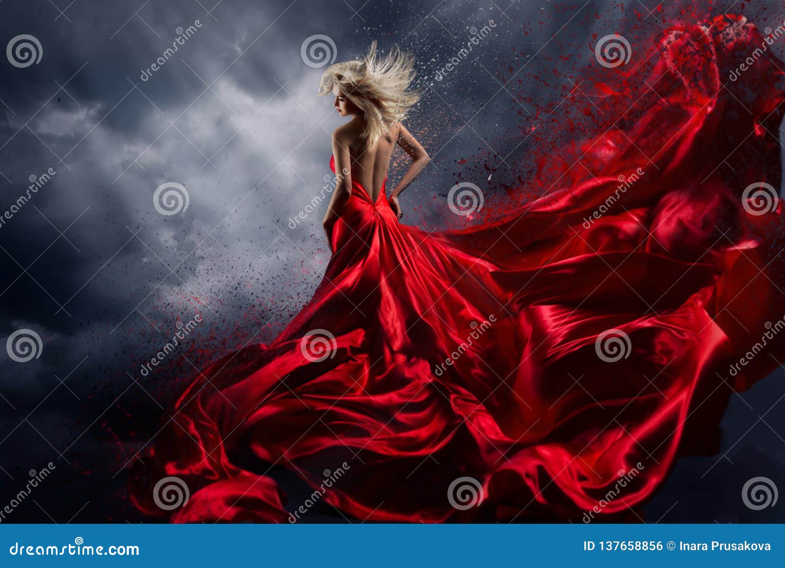 woman in red dress dance over storm sky, gown fluttering fabric