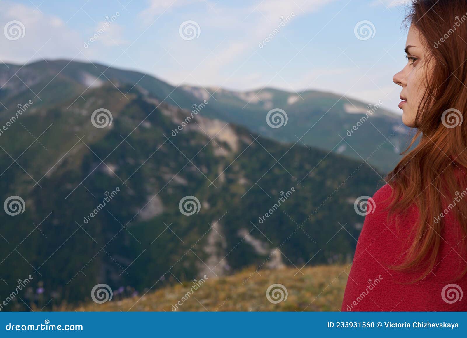 woman with red dress on nature in the mountains vacation adventure