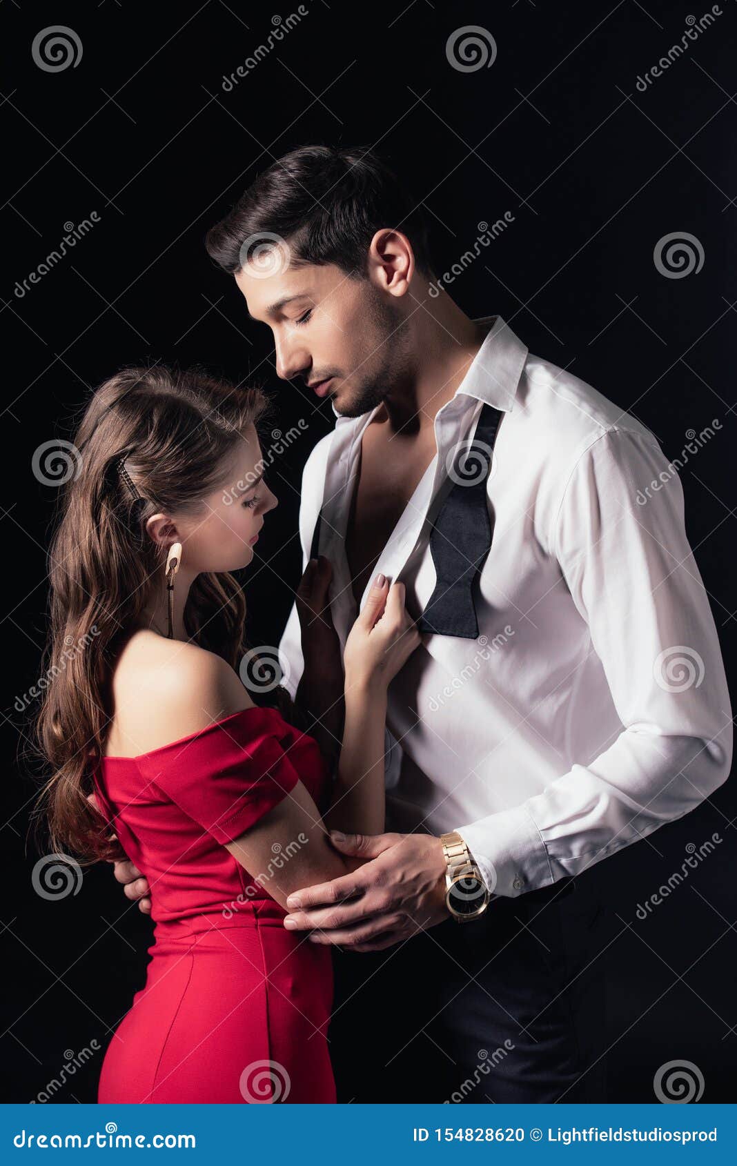 Woman in Red Dress Undressing Man Shirt Isolated Stock Photo image