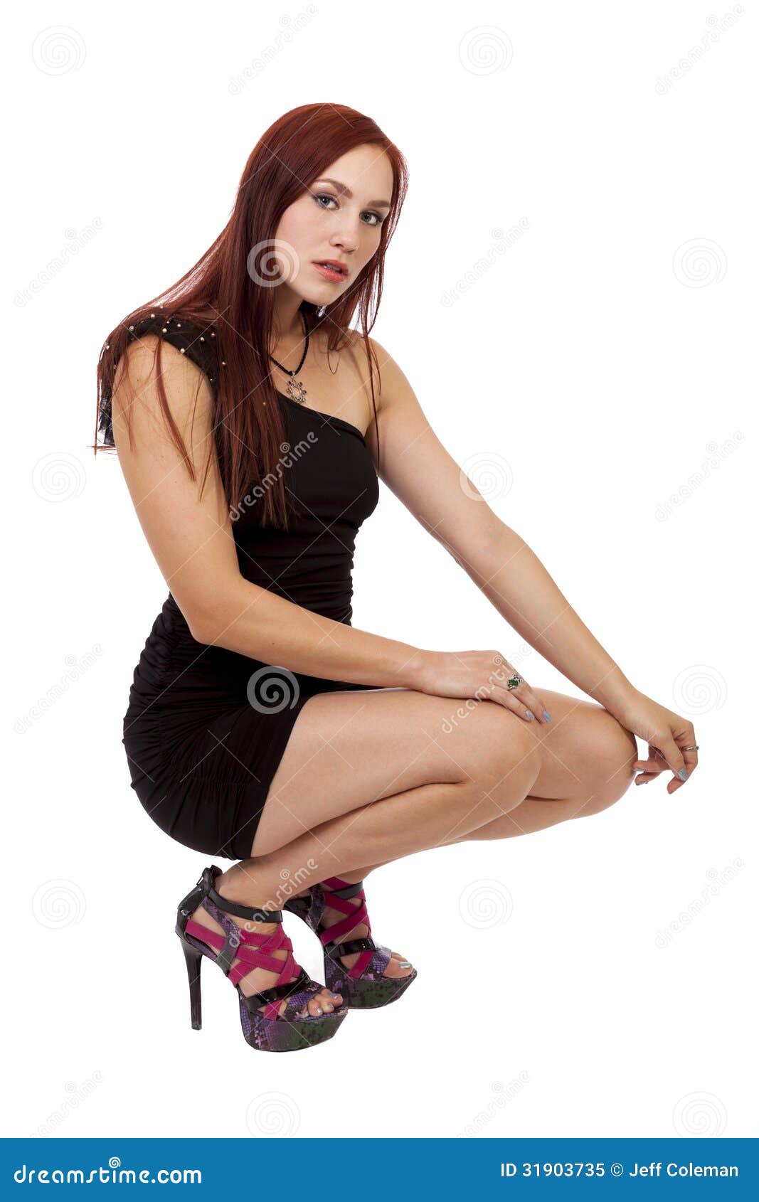 Woman with Red Hair Crouches Down in Her Little Black Dress. Stock ...