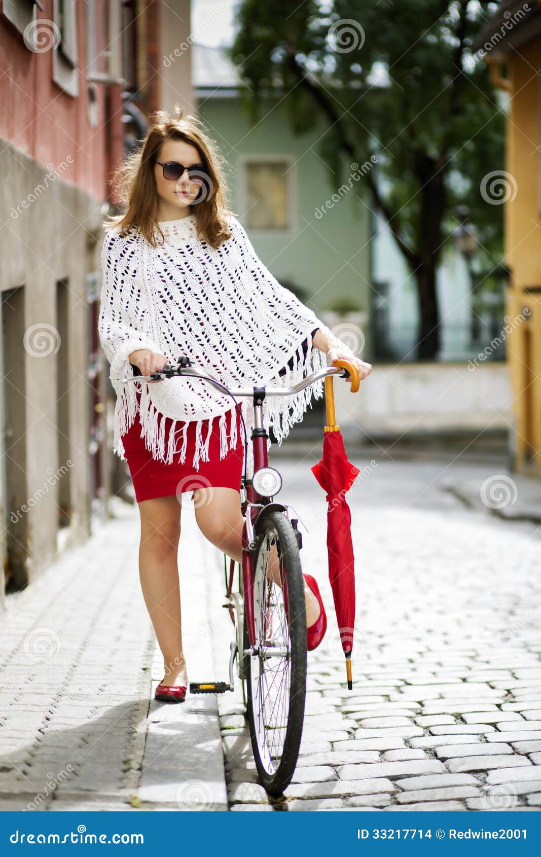 Woman in red put leg on bicycle pedal