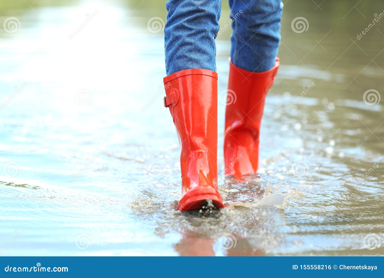 With Red Rubber Boots in Puddle, Closeup. Rainy Weather Stock Photo ...