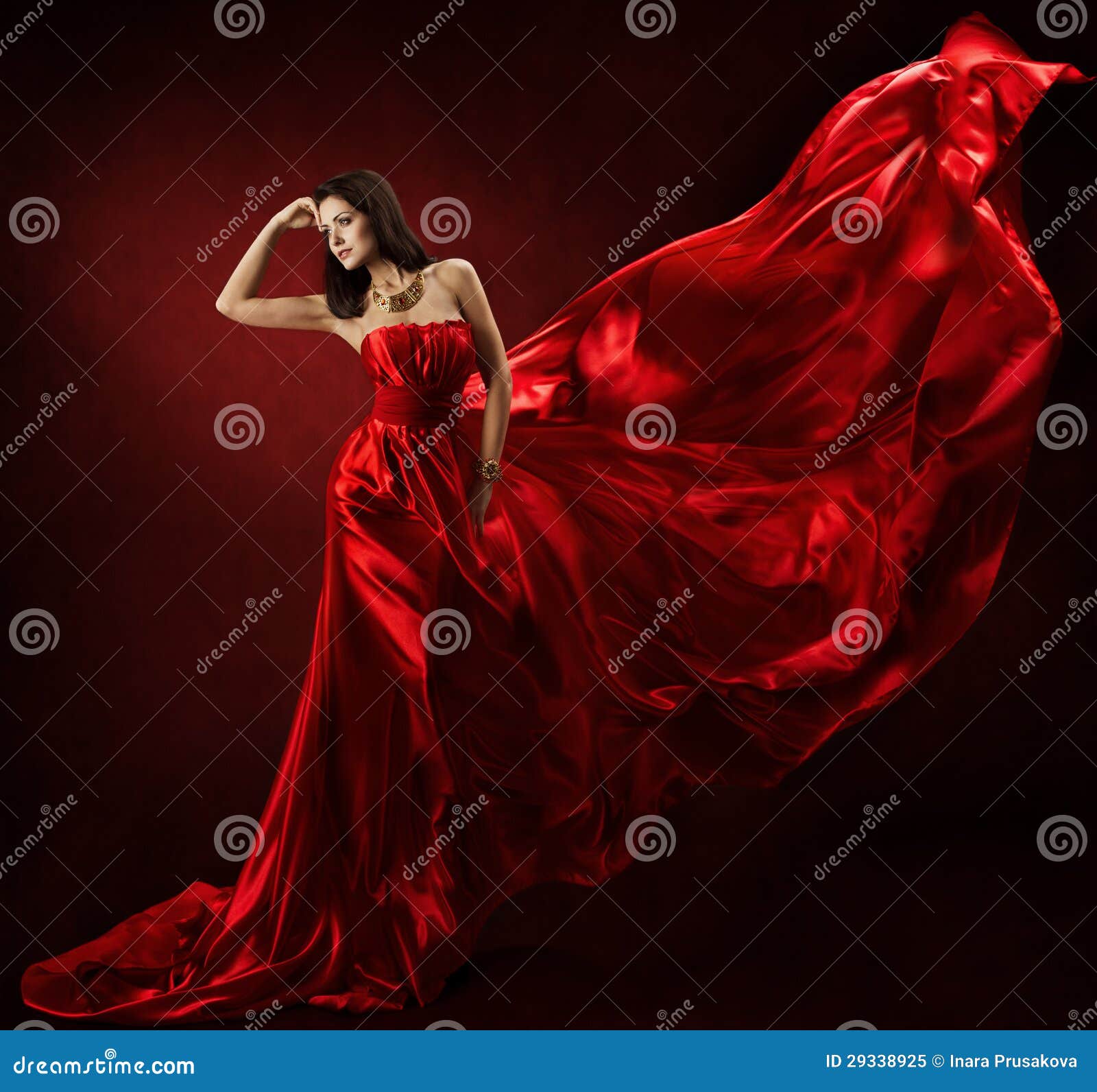 woman in red waving dress with flying fabric
