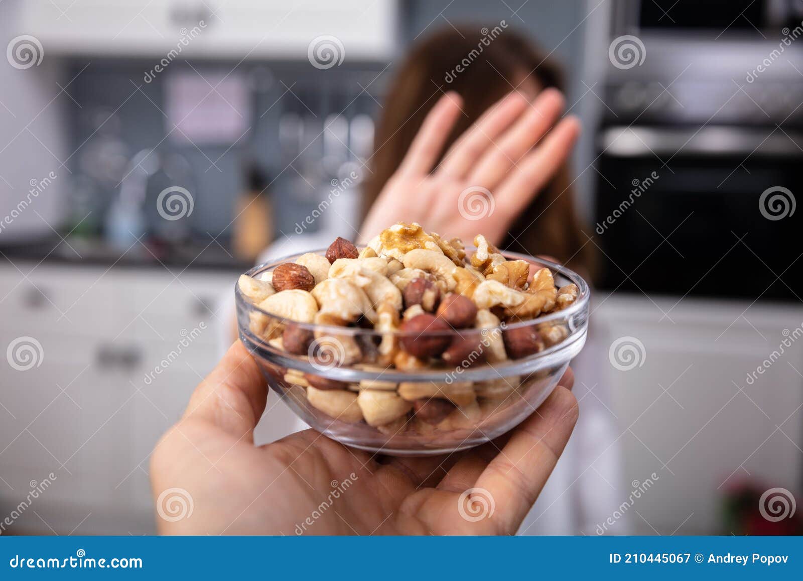 woman refusing bowl of nut food