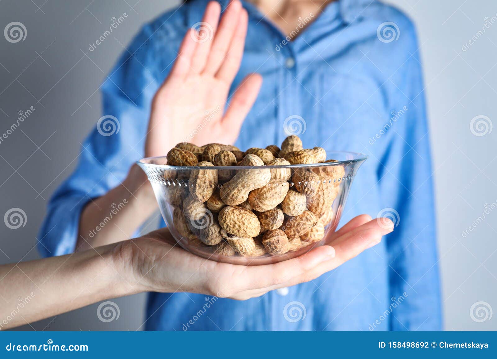 woman refusing to eat peanuts. food allergy concept