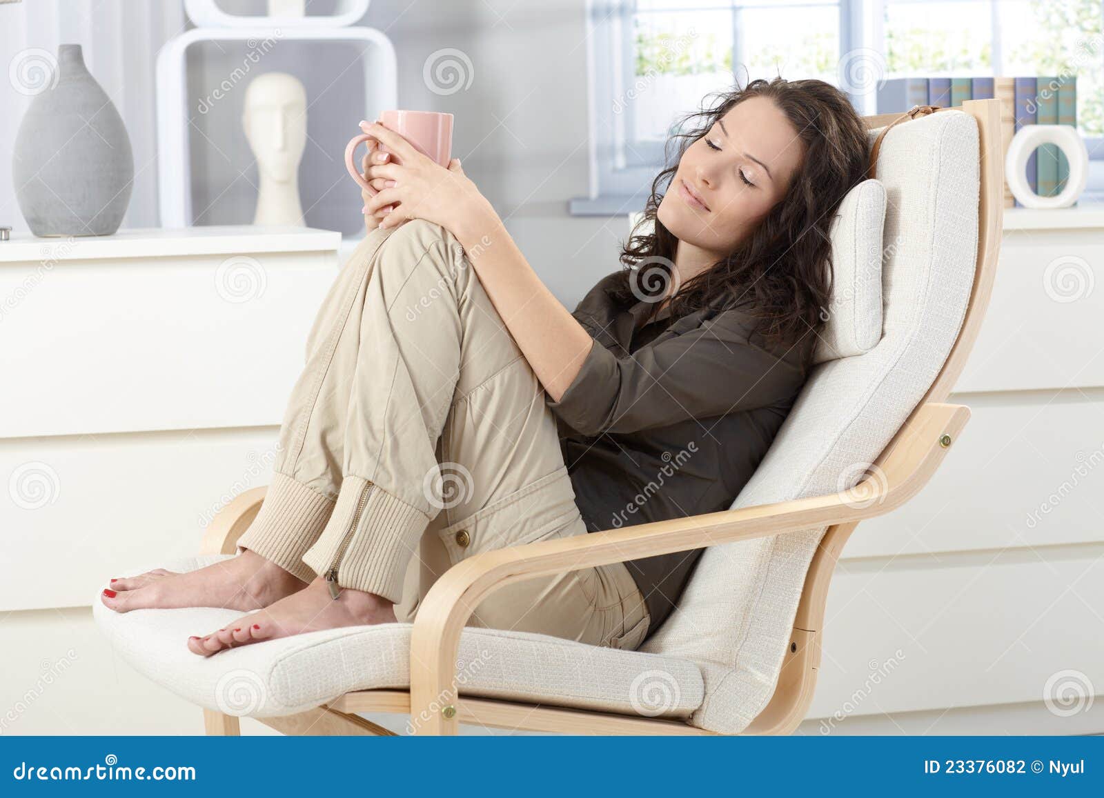 Woman relaxing in armchair stock photo. Image of armchair 23376082