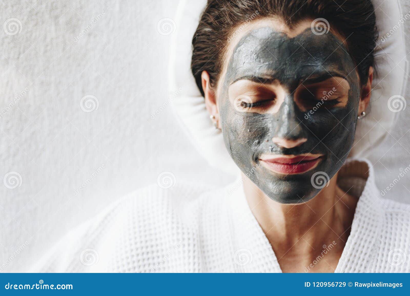woman relaxing with a charcoal facial mask