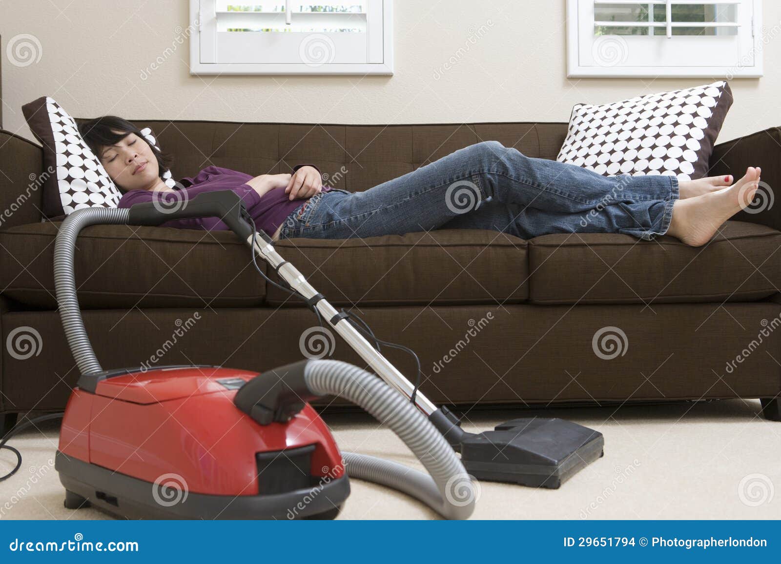Woman Relaxing on Couch with Vacuum Cleaner Stock Photo Image of home