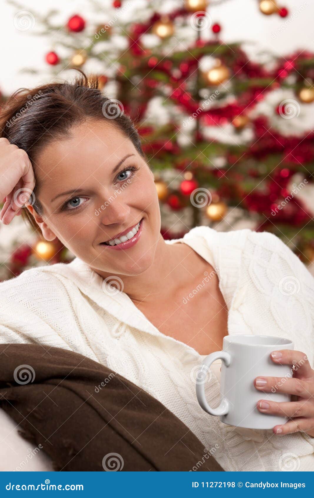 Woman Relaxing in Front of Christmas Tree Stock Photo - Image of ...