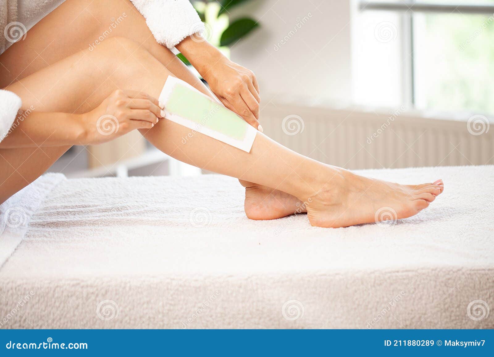 Woman Removes Wax with Hair from Legs. Stock Image - Image of cosmetic