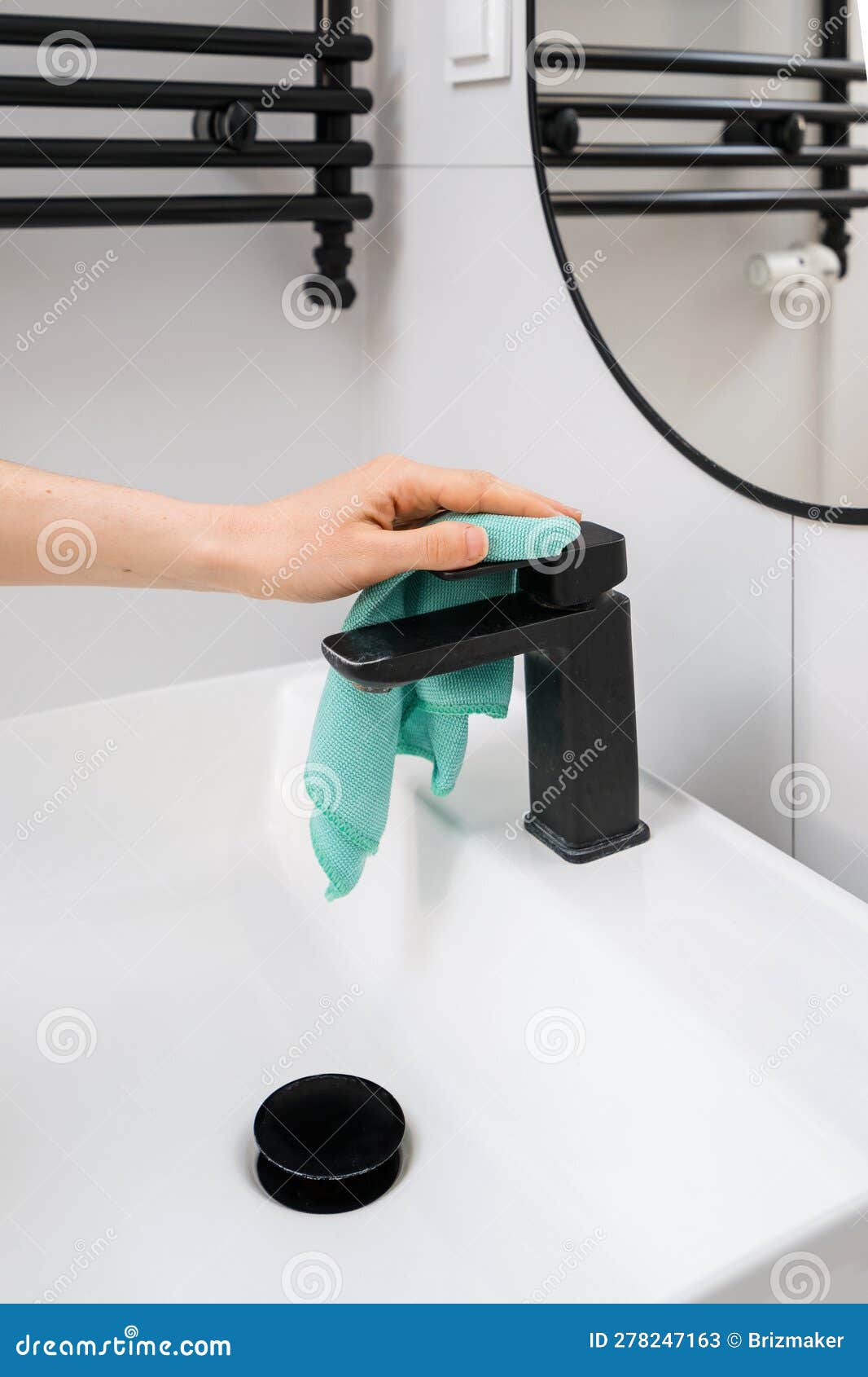 woman removing dirt and scale from water tap in bathroom