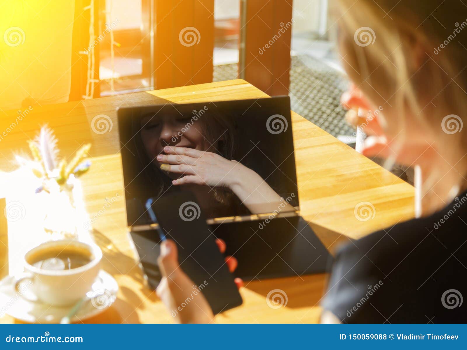 Woman Resting in Cafe. Girl Using Laptop and Smartphone and Chatting ...