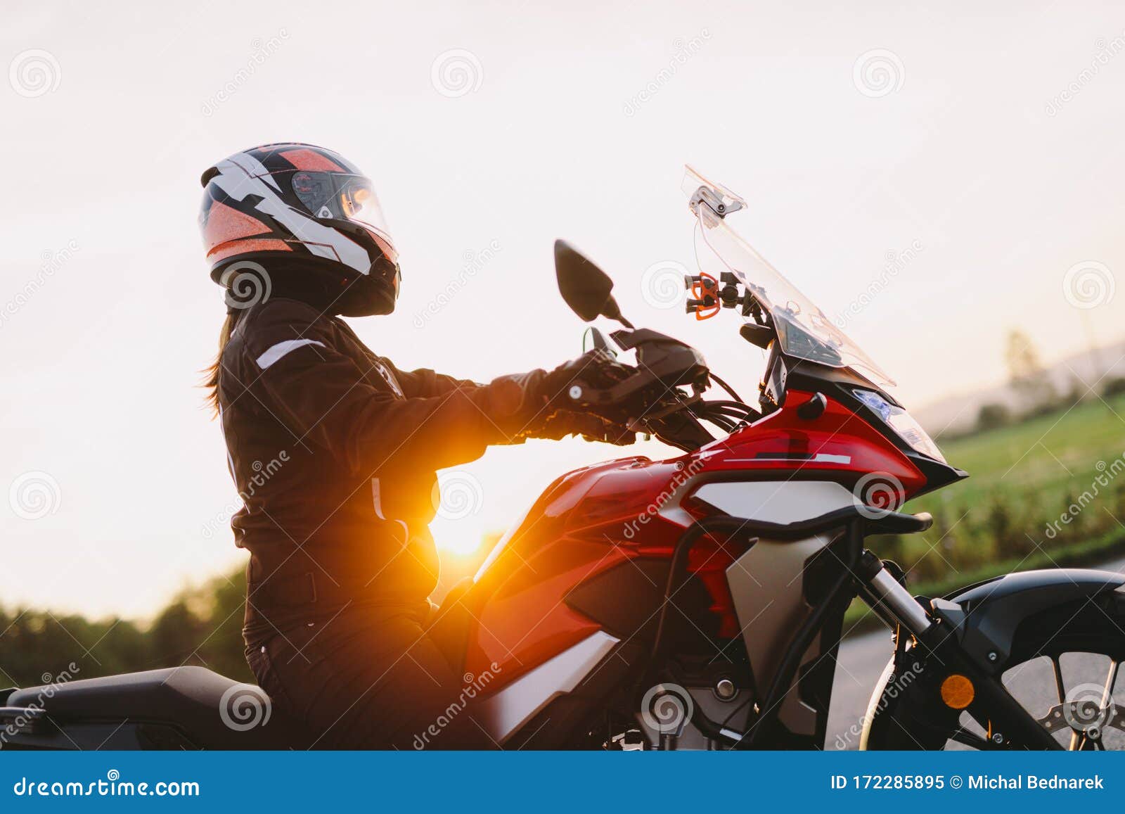 woman riding motobike at sunset.