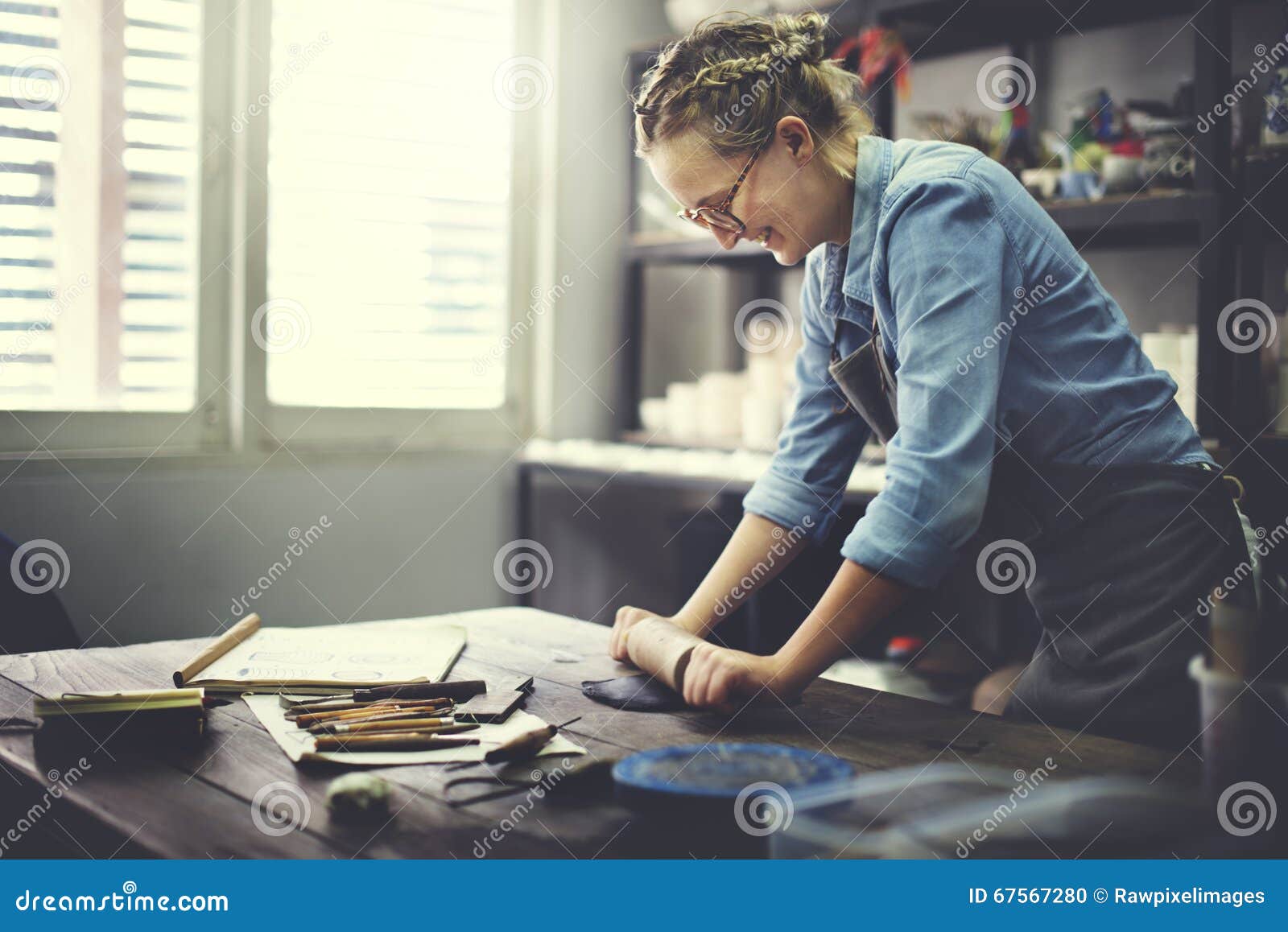 woman rolling clay craftsman skill concept