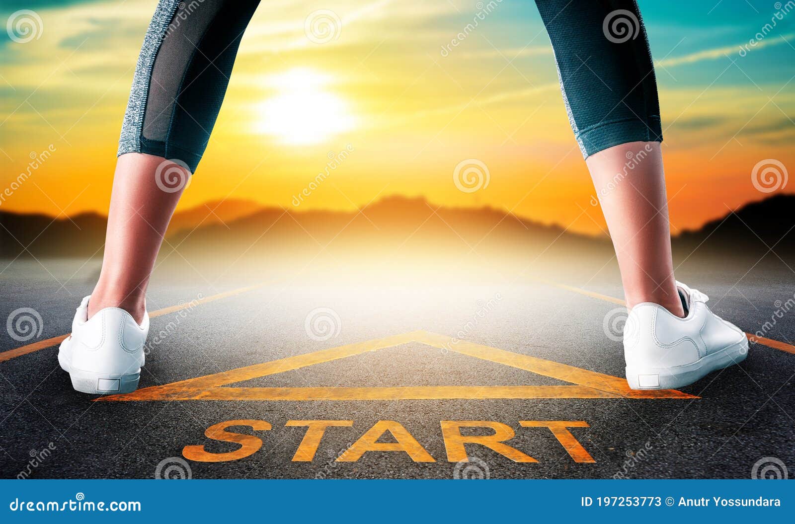 woman runner standing on a start sign ready to run to goal and freedom on sunset sky for motivation begining concept