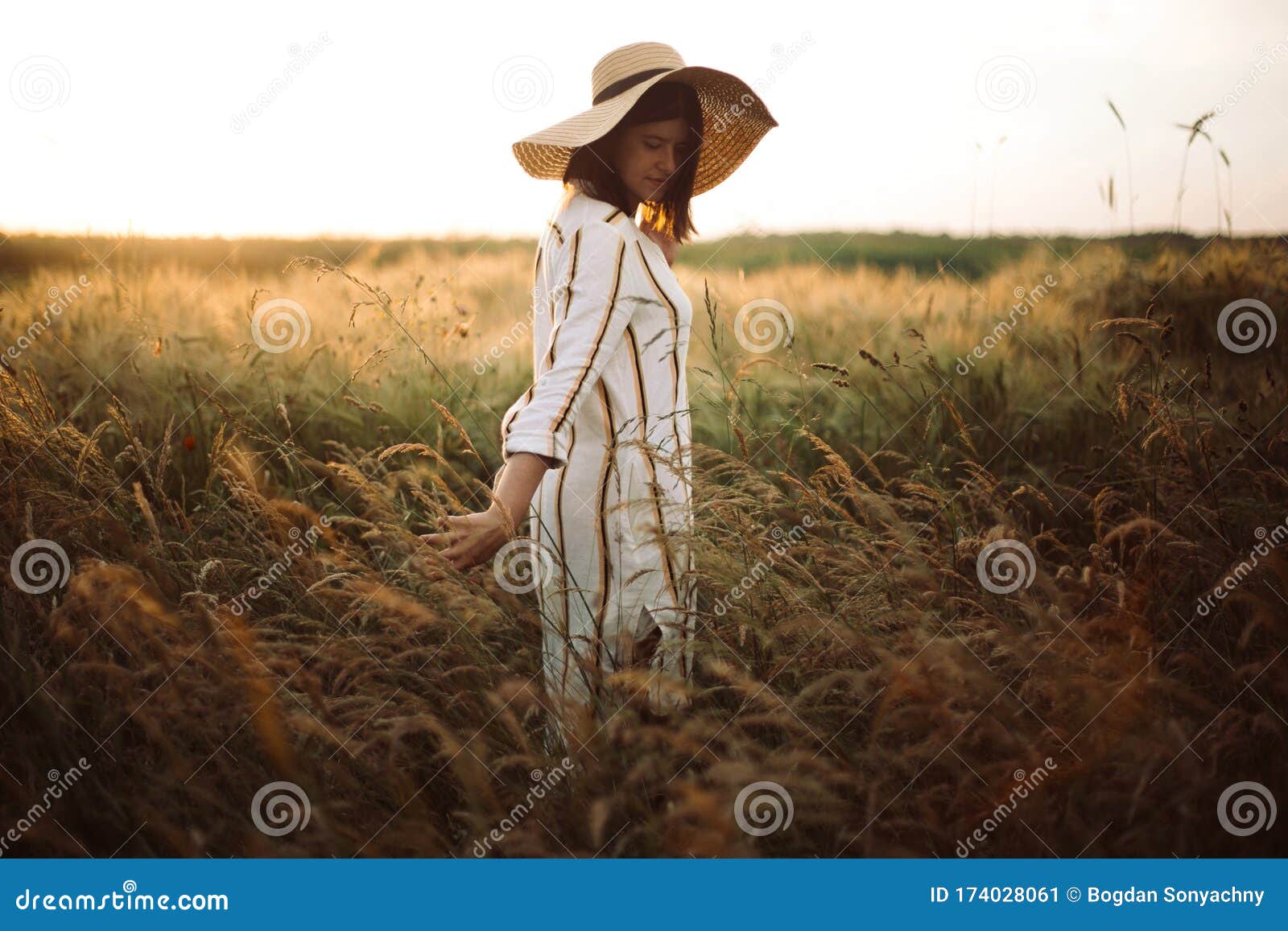 Woman in Rustic Dress and Hat Walking in Wildflowers and Herbs in ...