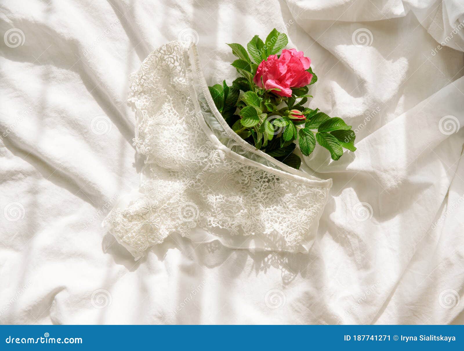 Woman`s Bra on Unmade Bed.Openwork White Cotton Underpants on