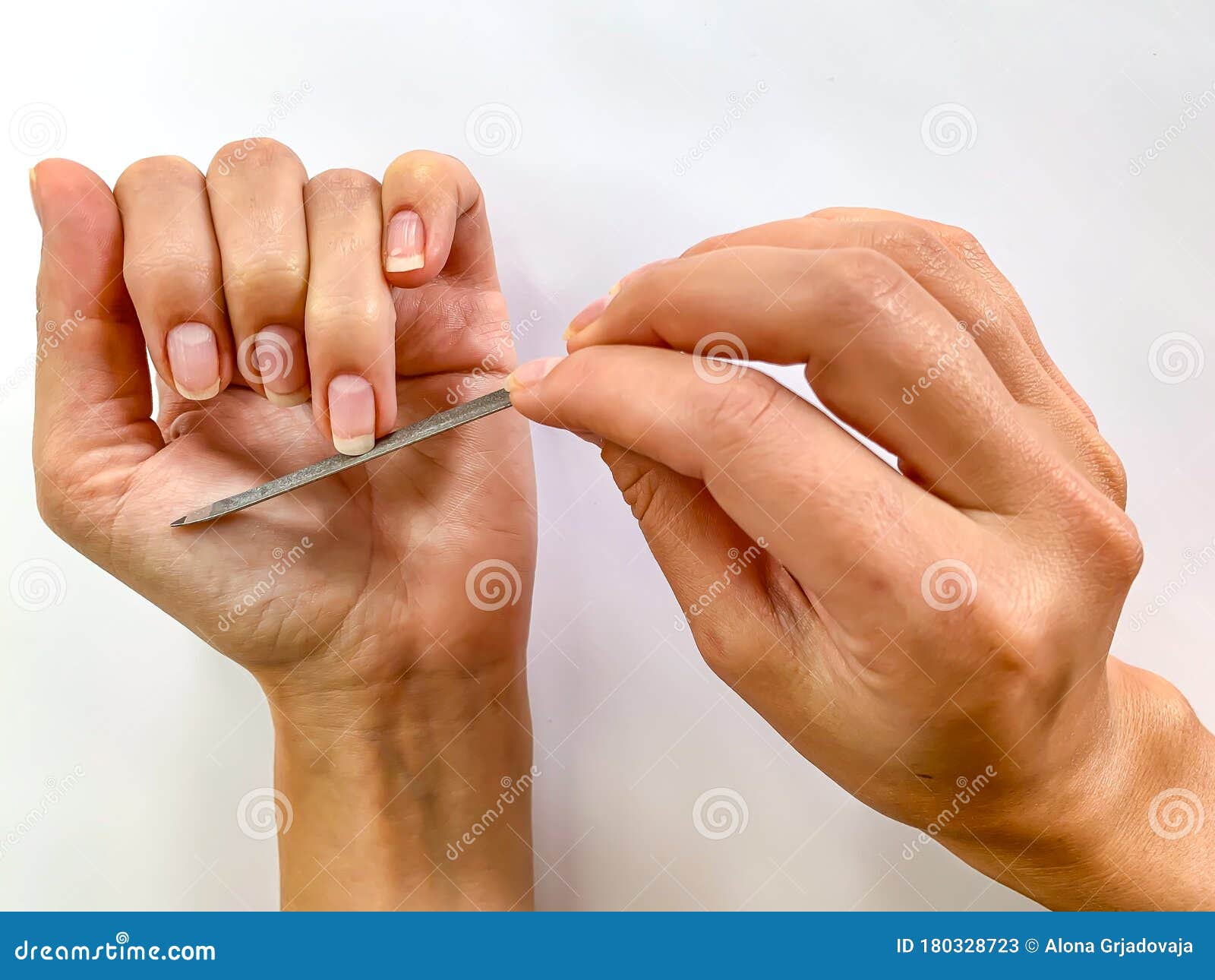 Womans Girls Hand Filing Nails With Metal Nail File On A White