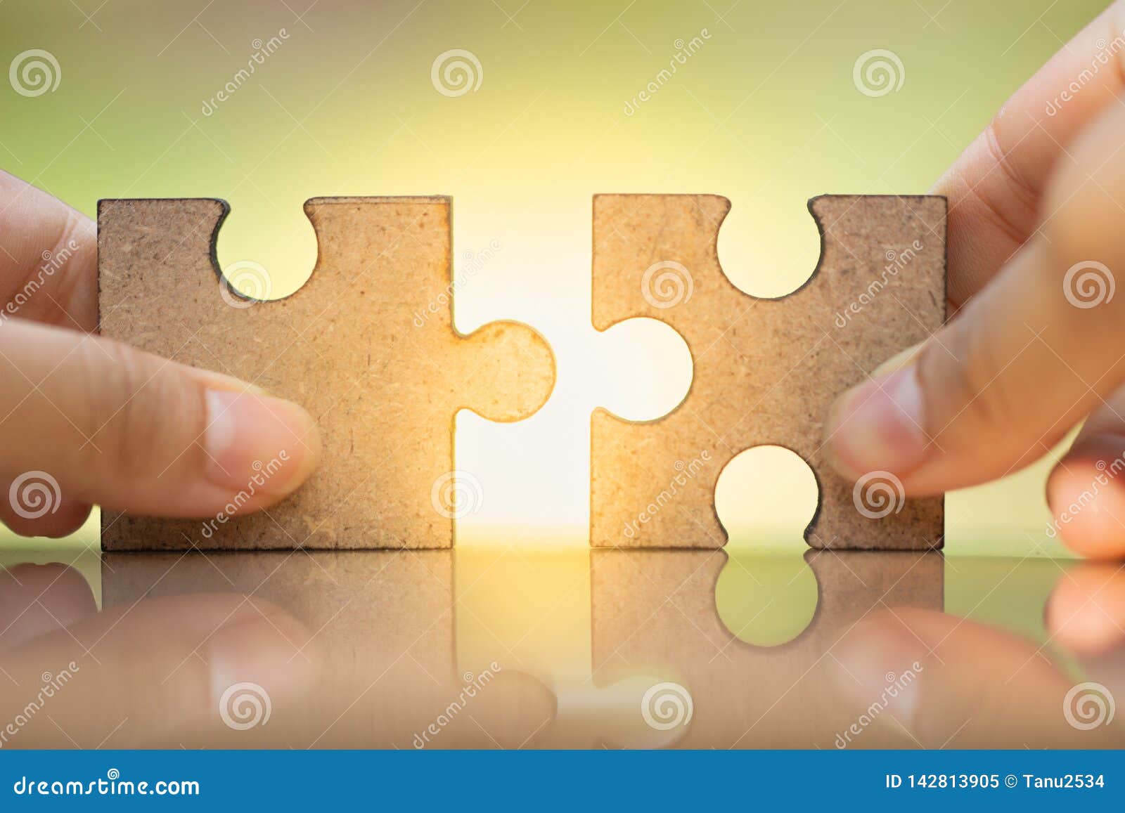 woman`s hand holding and connecting jigsaw puzzles.