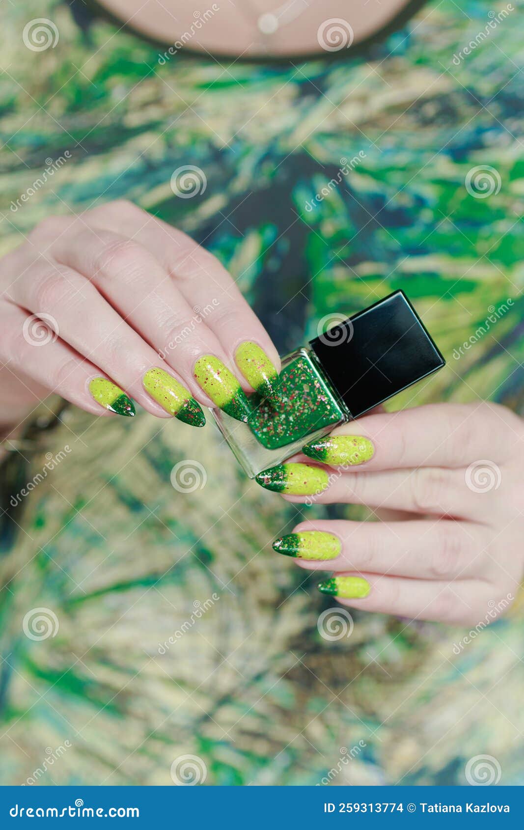 woman's hand with long nails and bright yellow green thermo manicure