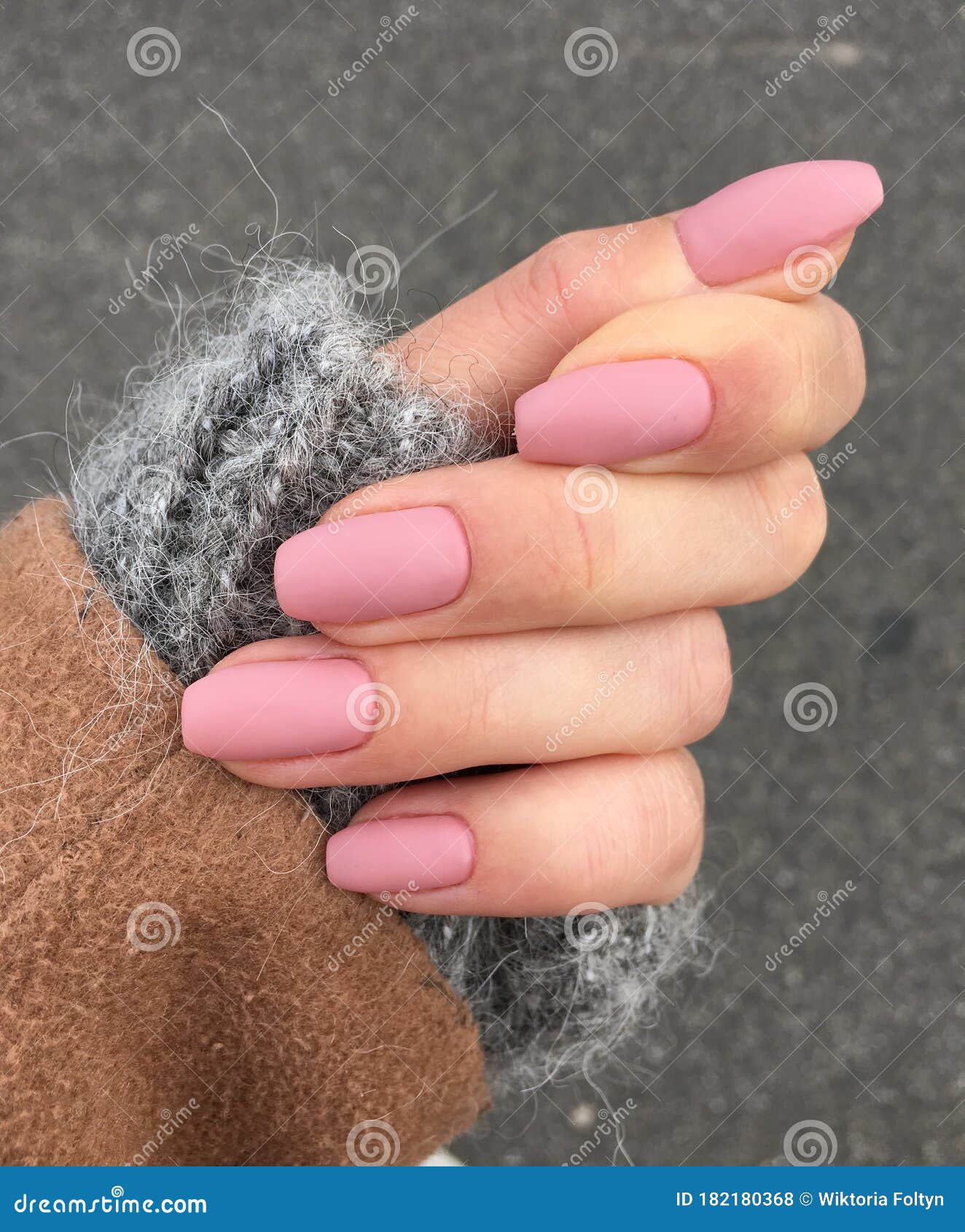 woman`s hand with pink manicure