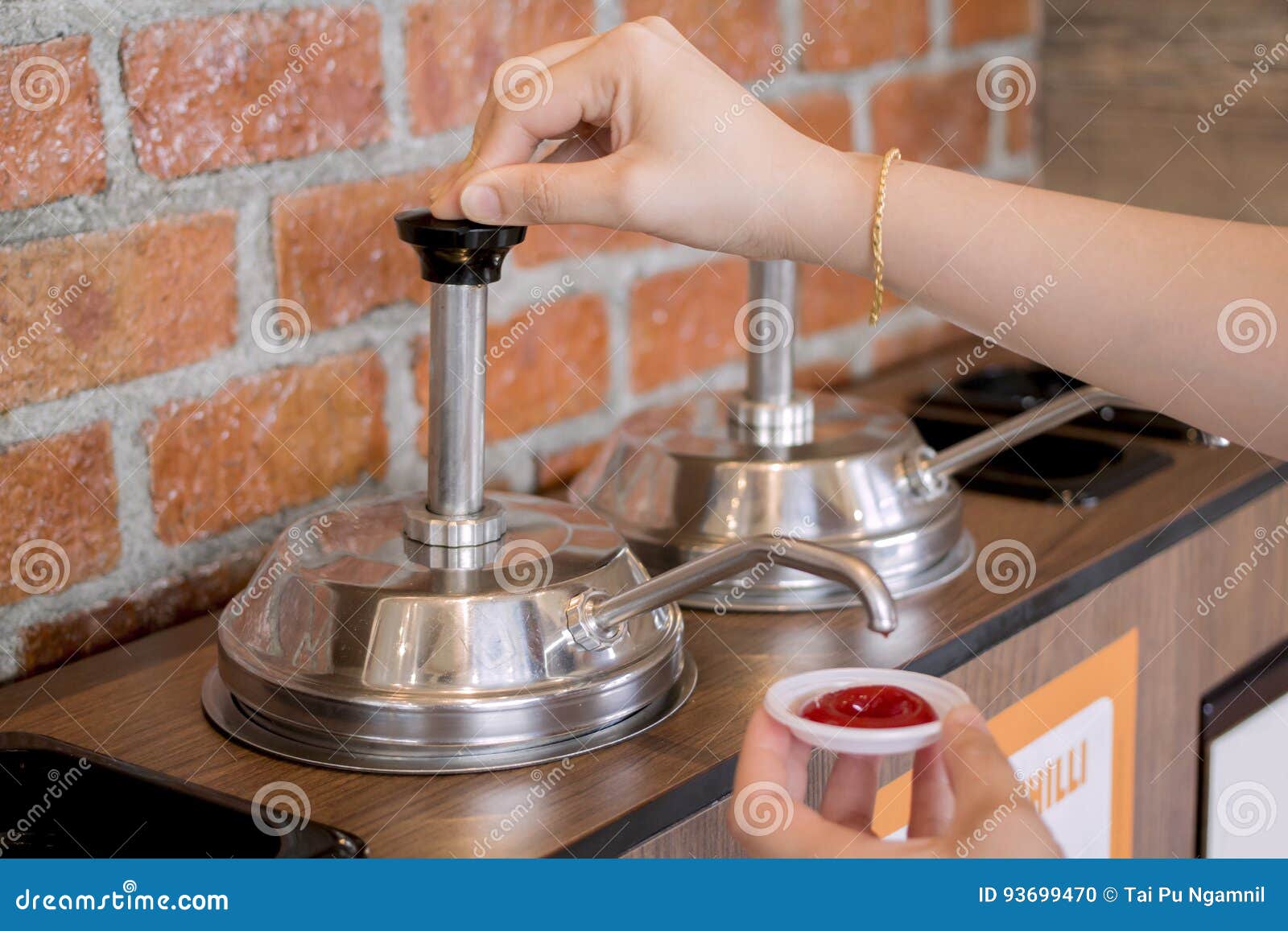 Woman`s Hand Pumping The Ketchup Pump Stock Photo Image of green