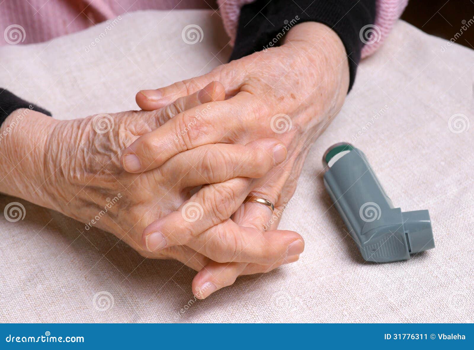 woman's hands and asthma inhaler