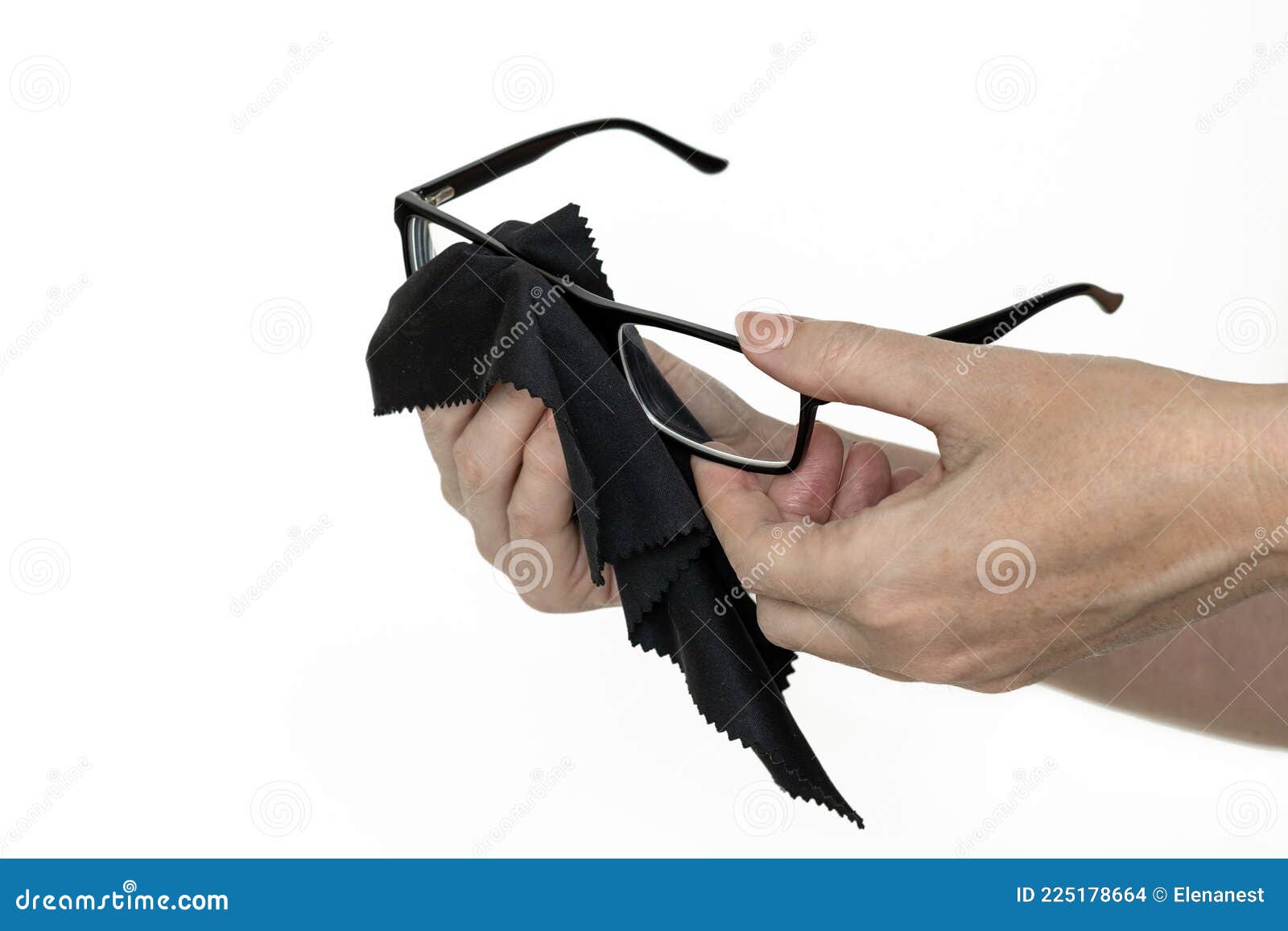 woman`s hands cleaning up glasses in black frame, 