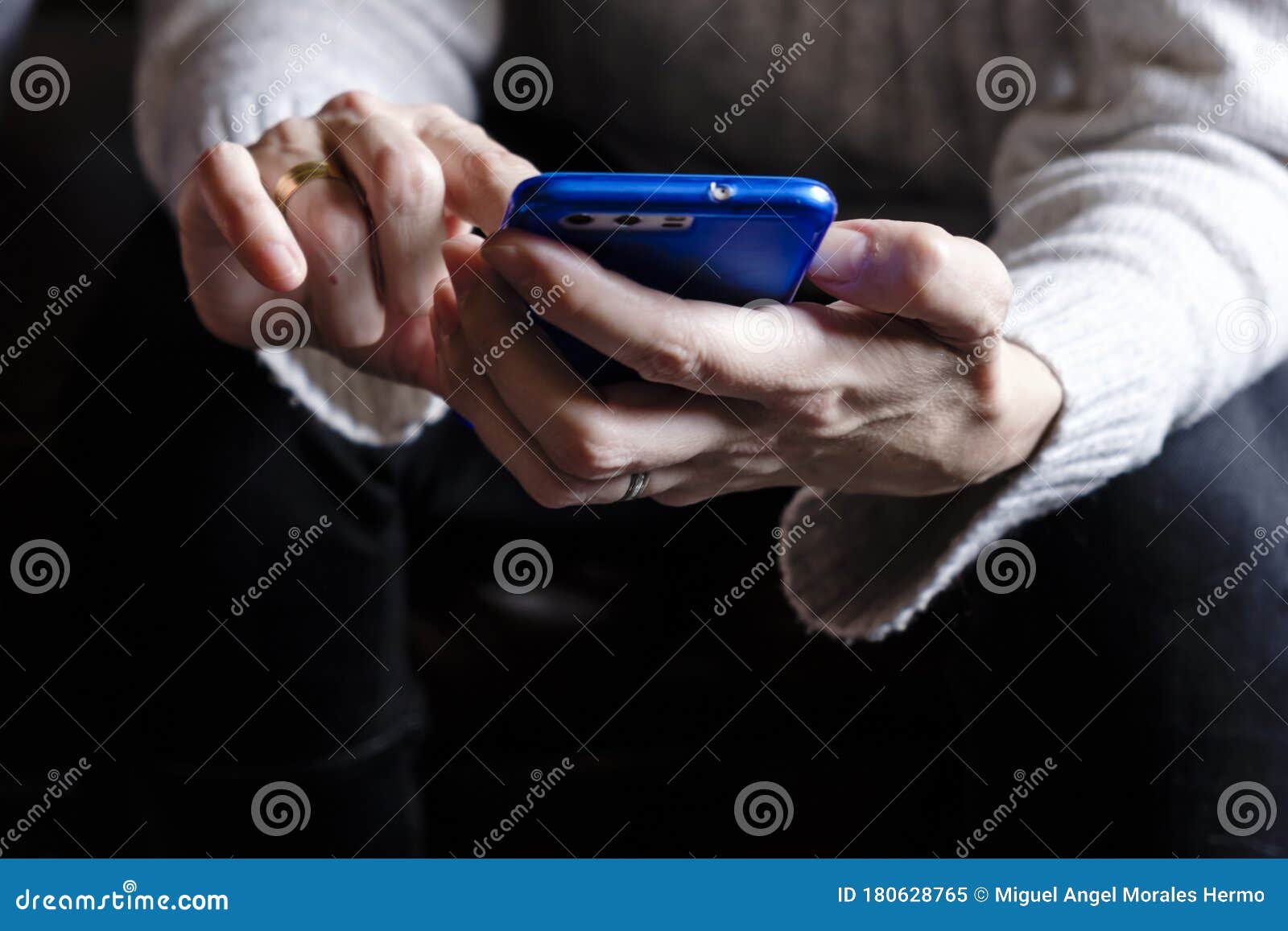 woman`s hands holding a smartphone