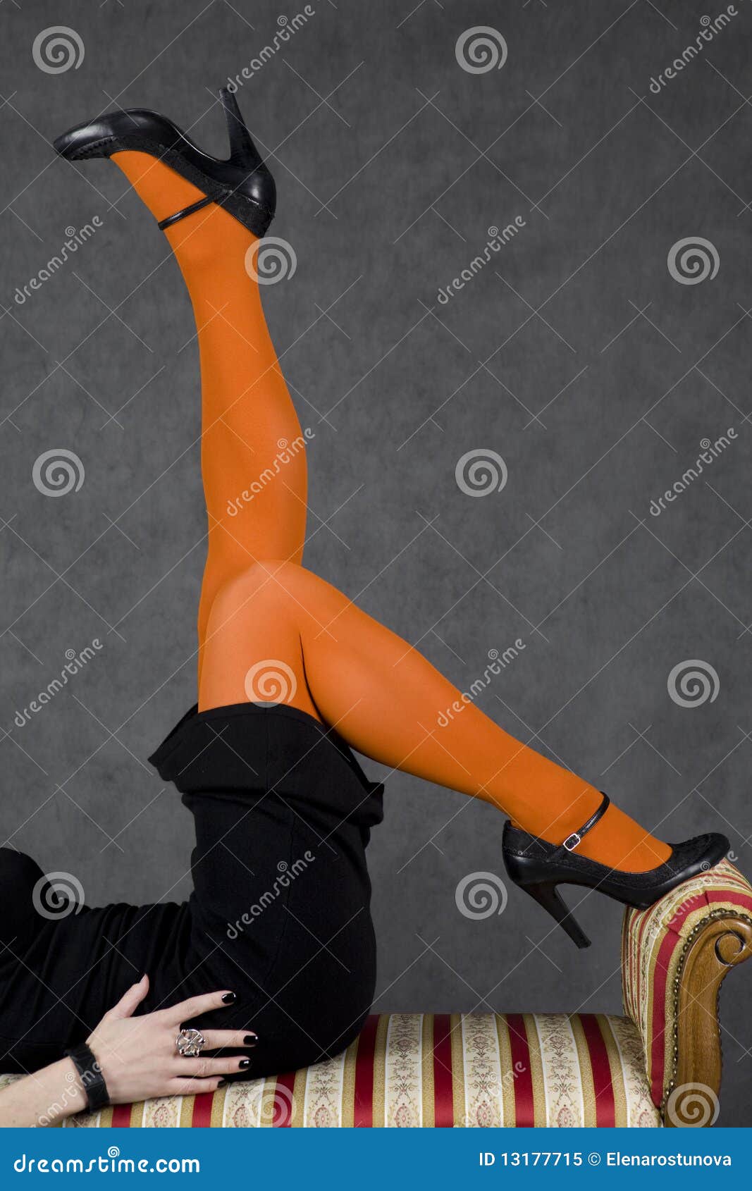Wall Mural Sexy woman's legs in orange tights 