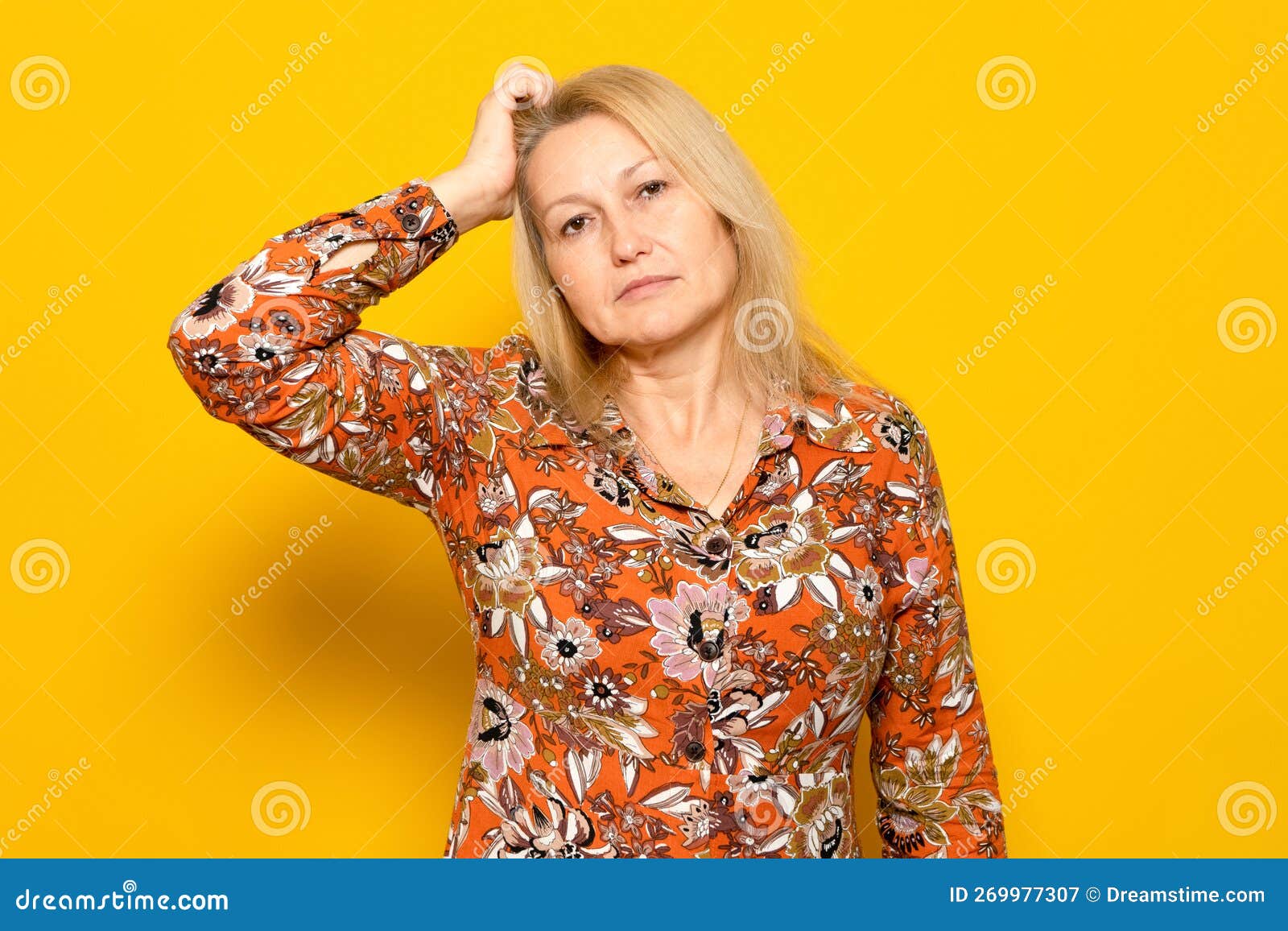 Woman Scratching Her Head With Doubts And Confusion Isolated On Yellow