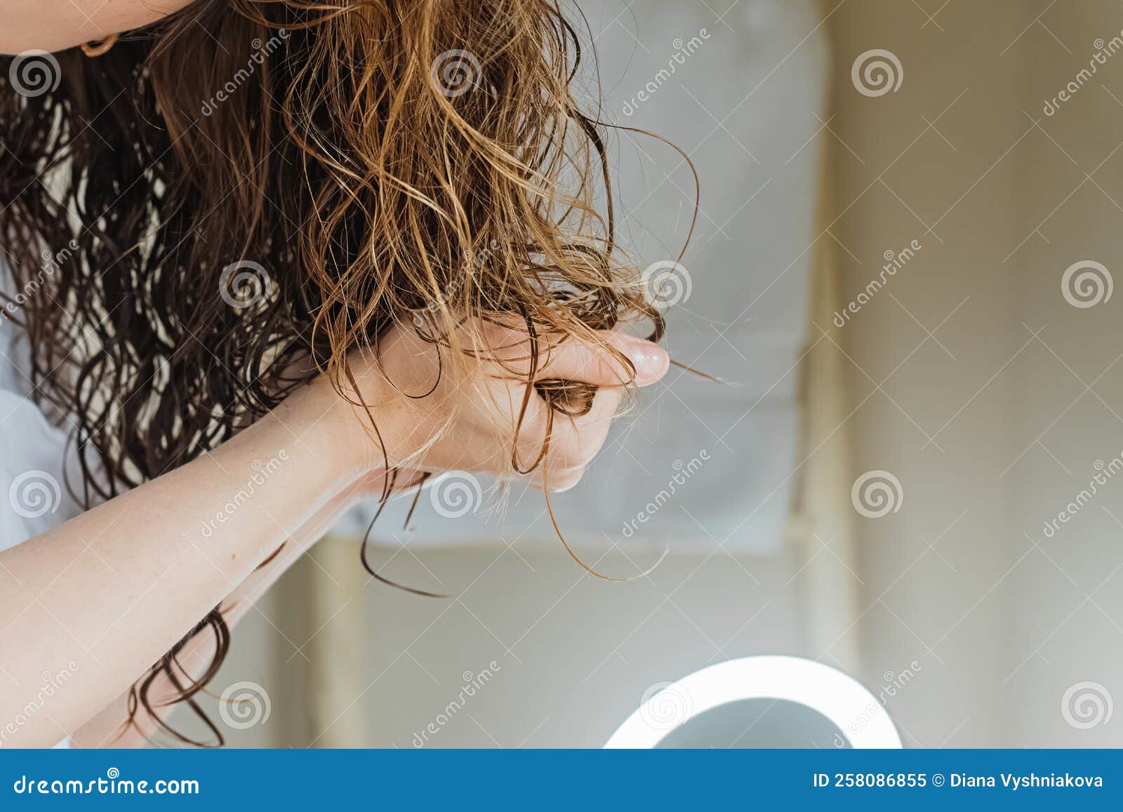 woman scrunching her hair to form curls.