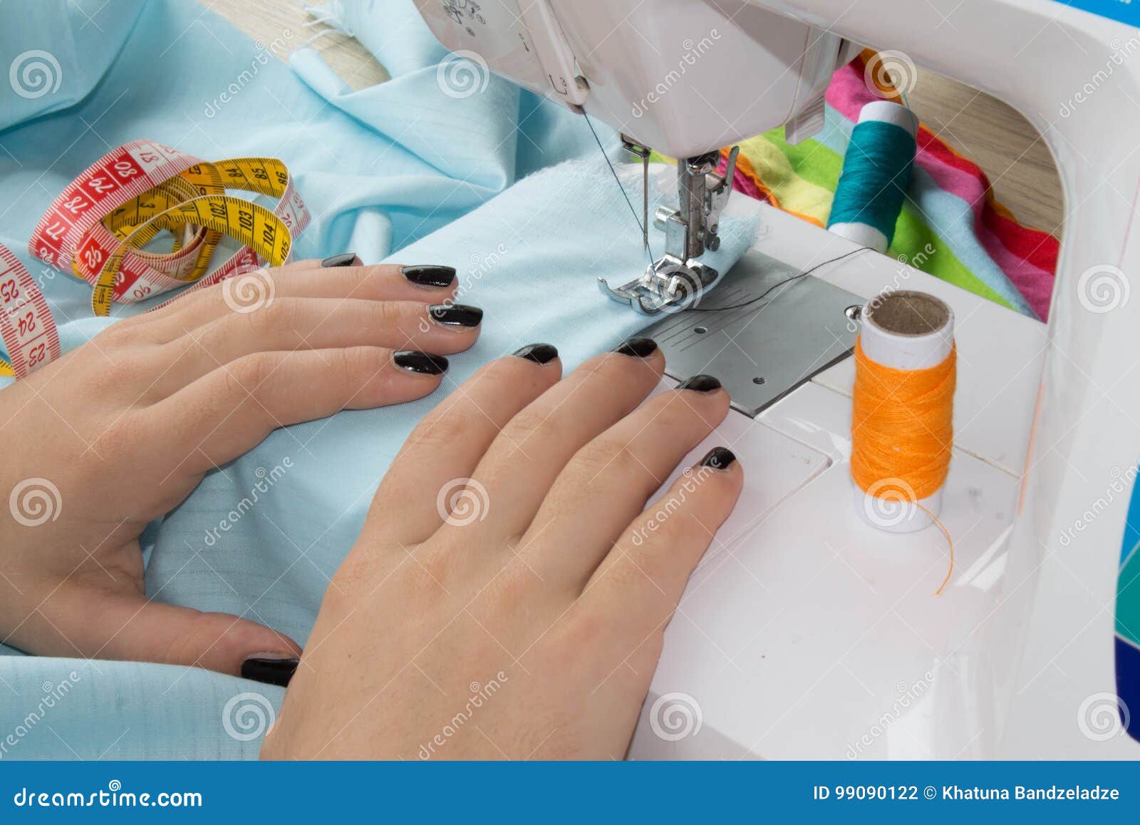 Woman Seamstress Sitting And Sews On Sewing Machine Dressmaker