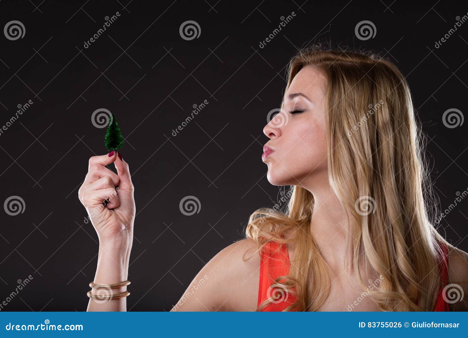 Woman Sending Kisses To a Little Tree Stock Photo - Image of hair ...