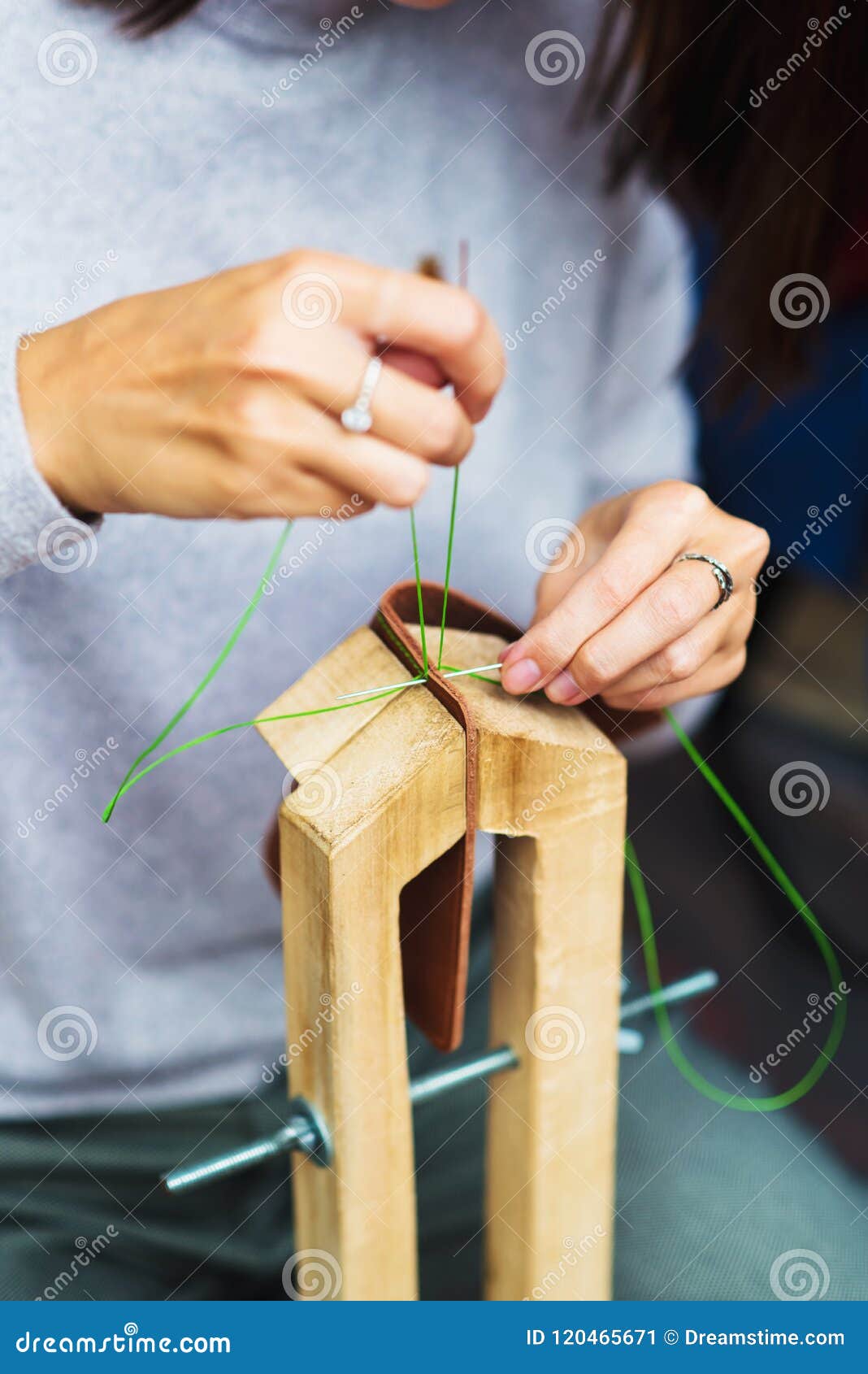 Woman while Sewing a Dress in Leather ...