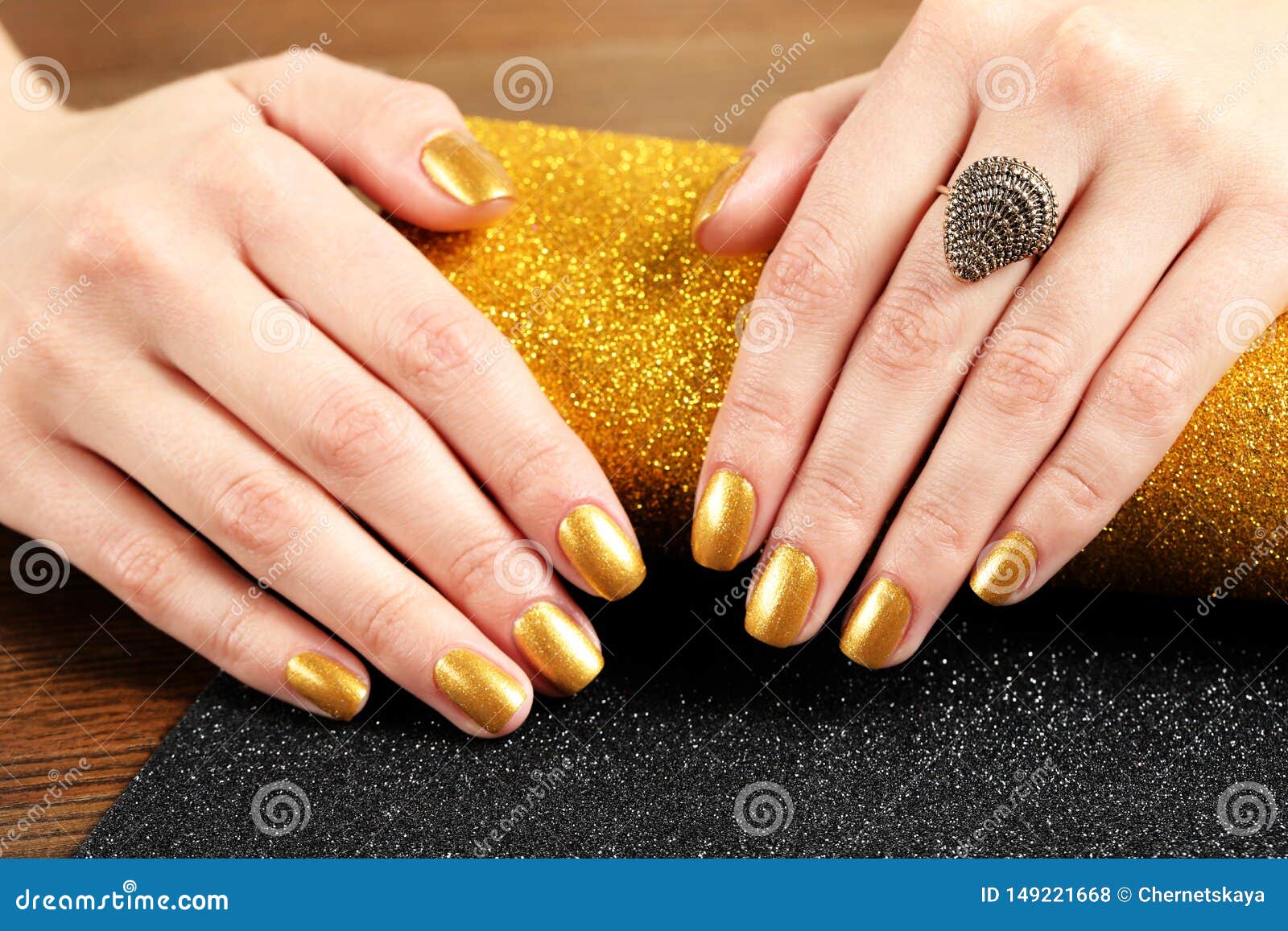 Woman Showing Manicured Hands with Golden Nail Polish on Table Stock ...