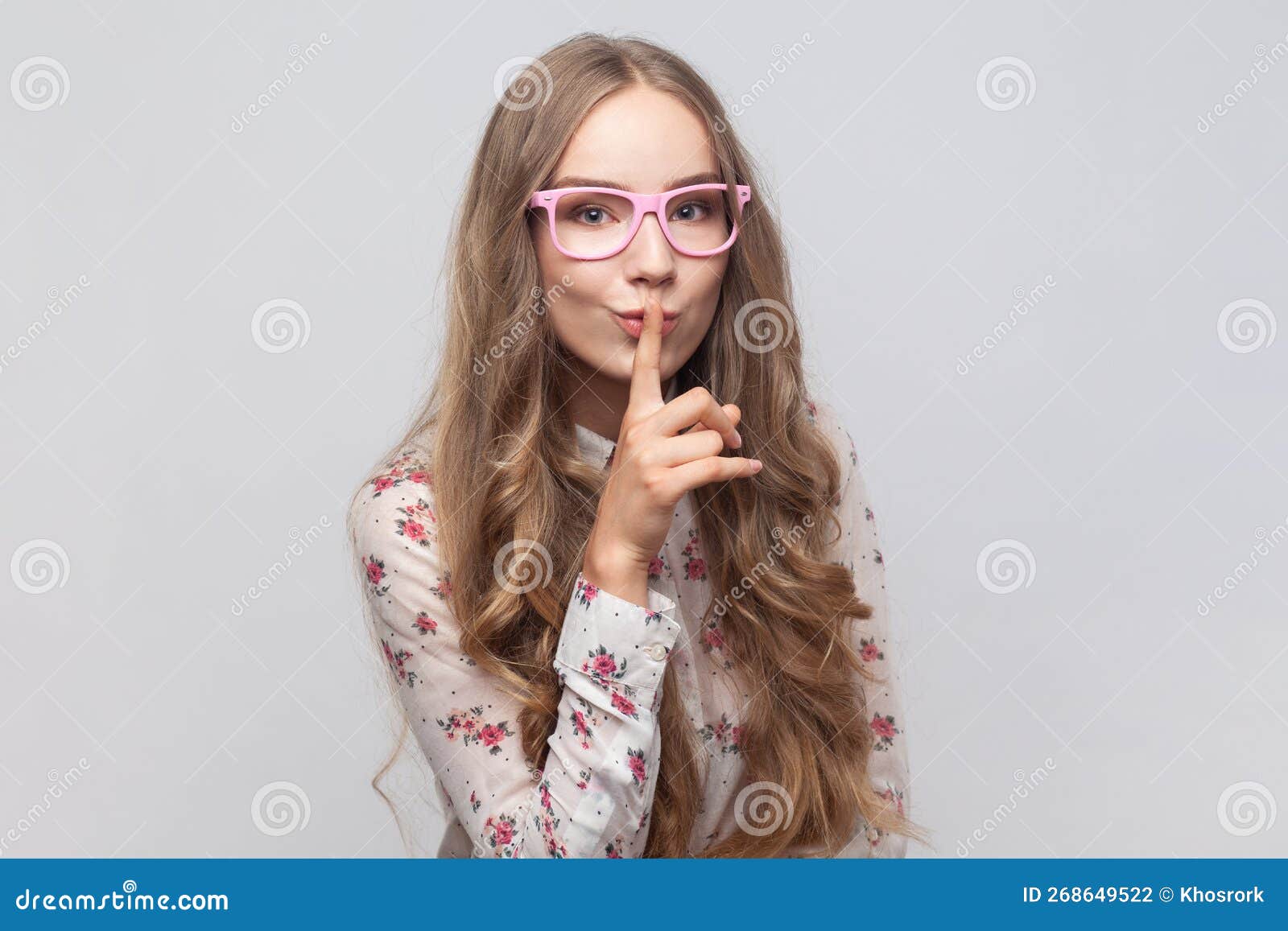 Woman Showing Shh Gesture Holding Finger Near Lips With Naughty Smile On Face Making Surprise