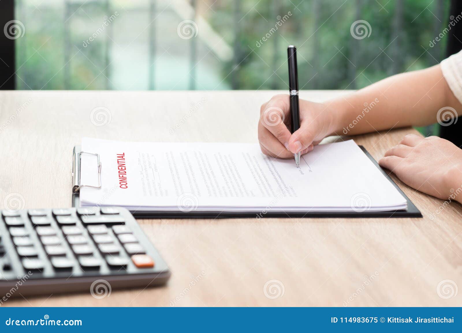 Woman Signing on Confidential Contract with Calculator on Wooden Stock ...