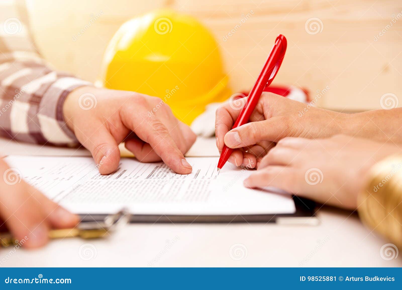 woman signing construction contract with contractor to build a house
