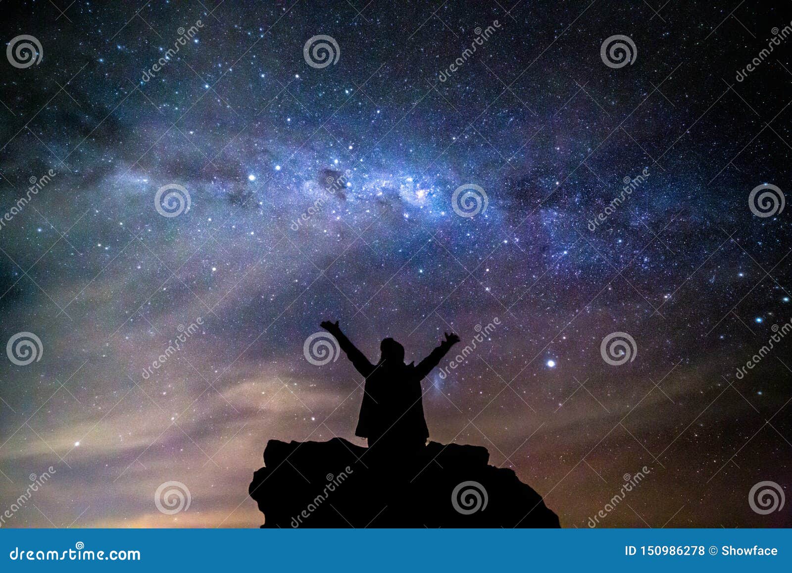silhouetted person hails the cosmos milky way starry night sky