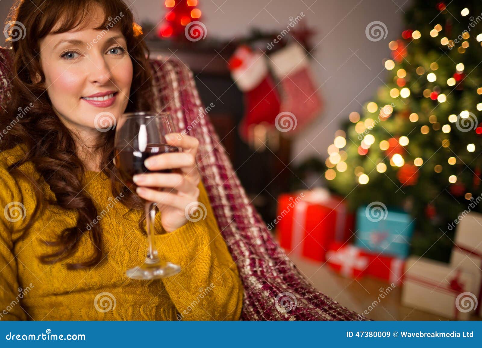 Woman Sitting on a Couch while Holding a Glass of Red Wine Stock Image ...